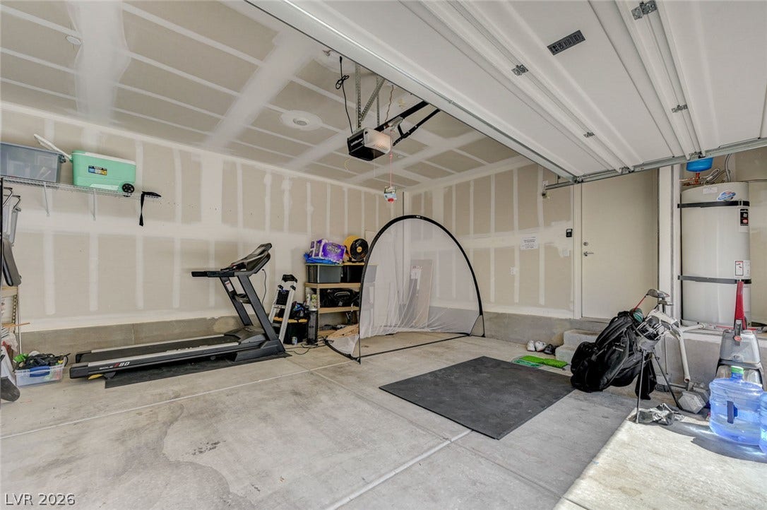An attached multi-car garage provides substantial utility space with durable concrete flooring.