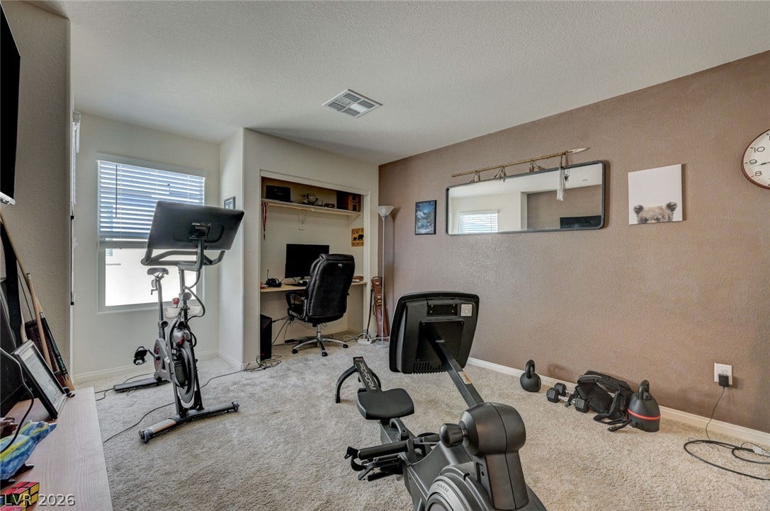 Plush carpeting and a recessed closet alcove highlight this versatile secondary bedroom space.