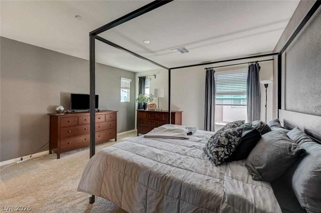 Plentiful natural light streams across the carpeted flooring of this peaceful bedroom retreat.