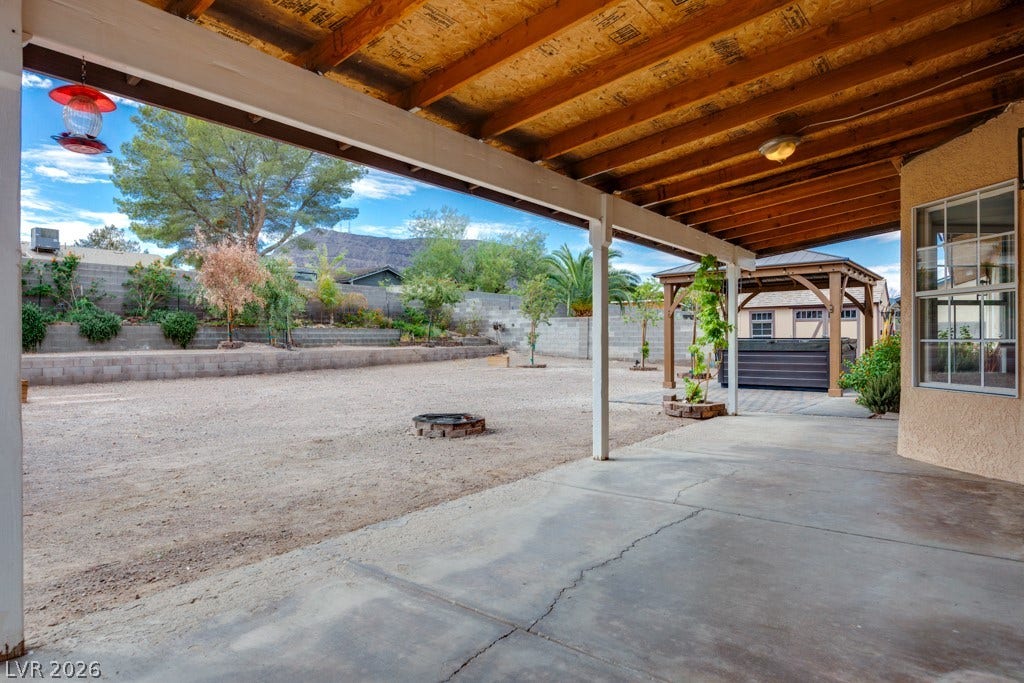251 W Laval Drive, Henderson, NV 89015 A large covered patio extends the living space outdoors, providing plenty of shade and room for dining, entertaining, or relaxing while enjoying the mountain backdrop.