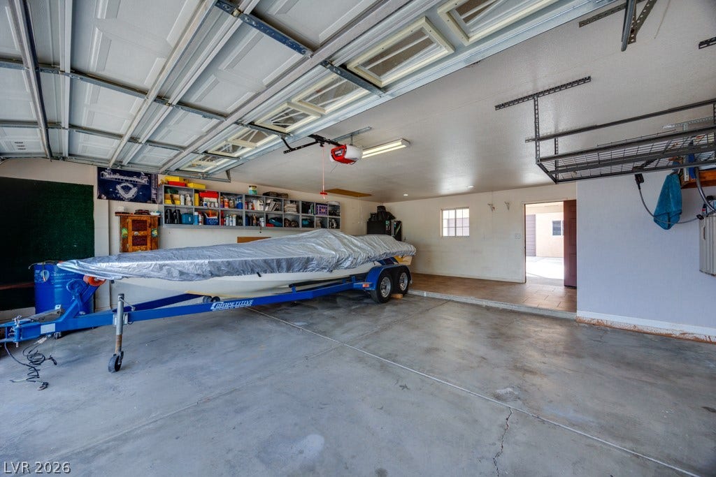 251 W Laval Drive, Henderson, NV 89015 Massive 29.5' x 25' garage delivers the ultimate combination of storage, workspace, and recreational flexibility. Featuring a full-size garage door, built-in storage, work areas, and expansive floor space, this is far more than a typical garage. The generous footprint easily accommodates vehicles, motorcycles, equipment, projects, and more. An exceptional setup for anyone who values space, functionality, and room to pursue their passions.