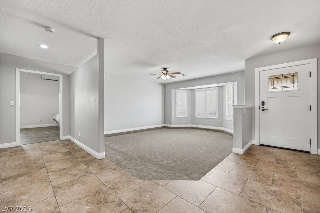 251 W Laval Drive, Henderson, NV 89015 Generously sized front living room with soft neutral finishes, abundant natural light, plantation shutters, and plenty of room to create a comfortable gathering space.