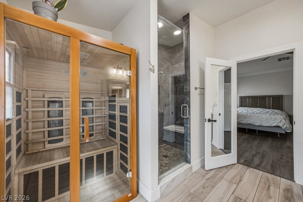 251 W Laval Drive, Henderson, NV 89015 The primary bath includes a private sauna alongside a beautifully tiled walk-in shower for an at-home spa experience.