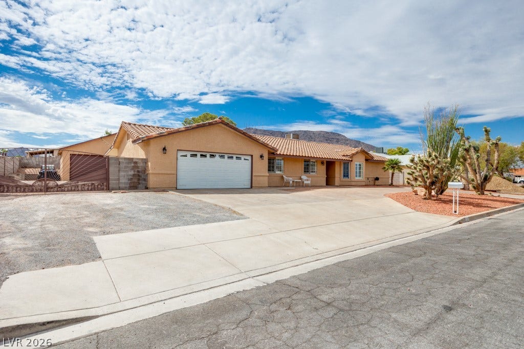 251 W Laval Drive, Henderson, NV 89015 Inviting single-story Henderson gem with classic Southwest architecture, no HOA, RV parking, mature desert landscaping, and an expansive horseshoe driveway offering plenty of off-street parking.