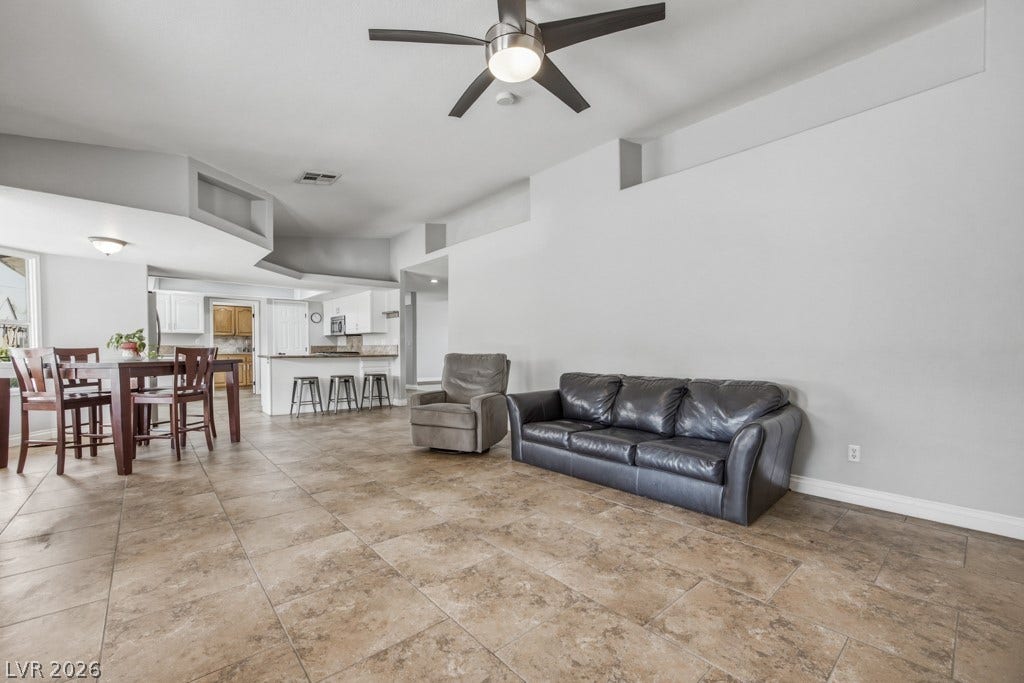 251 W Laval Drive, Henderson, NV 89015 The family room flows effortlessly into the dining area and kitchen, creating an open, connected layout that's ideal for entertaining and everyday life.