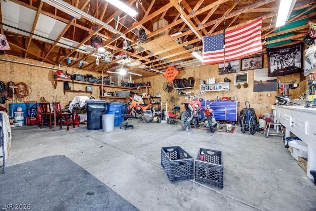 251 W Laval Drive, Henderson, NV 89015 Oversized 35' x 28.5', thoughtfully equipped detached garage/workshop offers an incredible amount of flexible workspace and storage. Finished with abundant built-in shelving, extensive work surfaces, bright overhead lighting, a swamp cooler, and plenty of room for vehicles, recreational equipment, tools, and hobbies. A true dream space for the hobbyist, mechanic, outdoor enthusiast, or anyone needing serious storage and workspace.