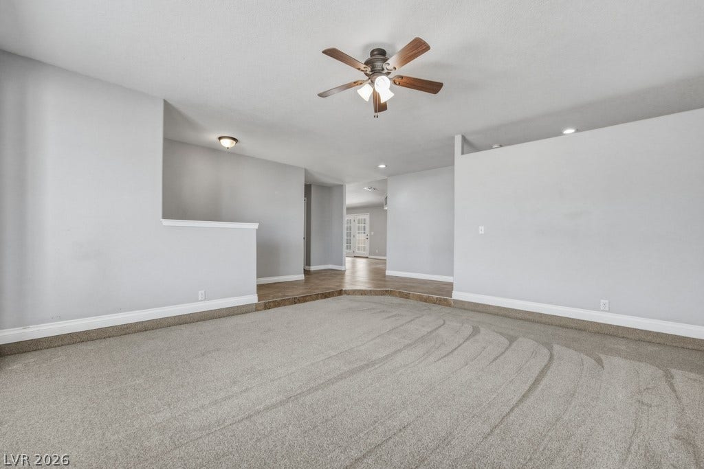 251 W Laval Drive, Henderson, NV 89015 Generously sized front living room with soft neutral finishes, abundant natural light, plantation shutters, and plenty of room to create a comfortable gathering space.