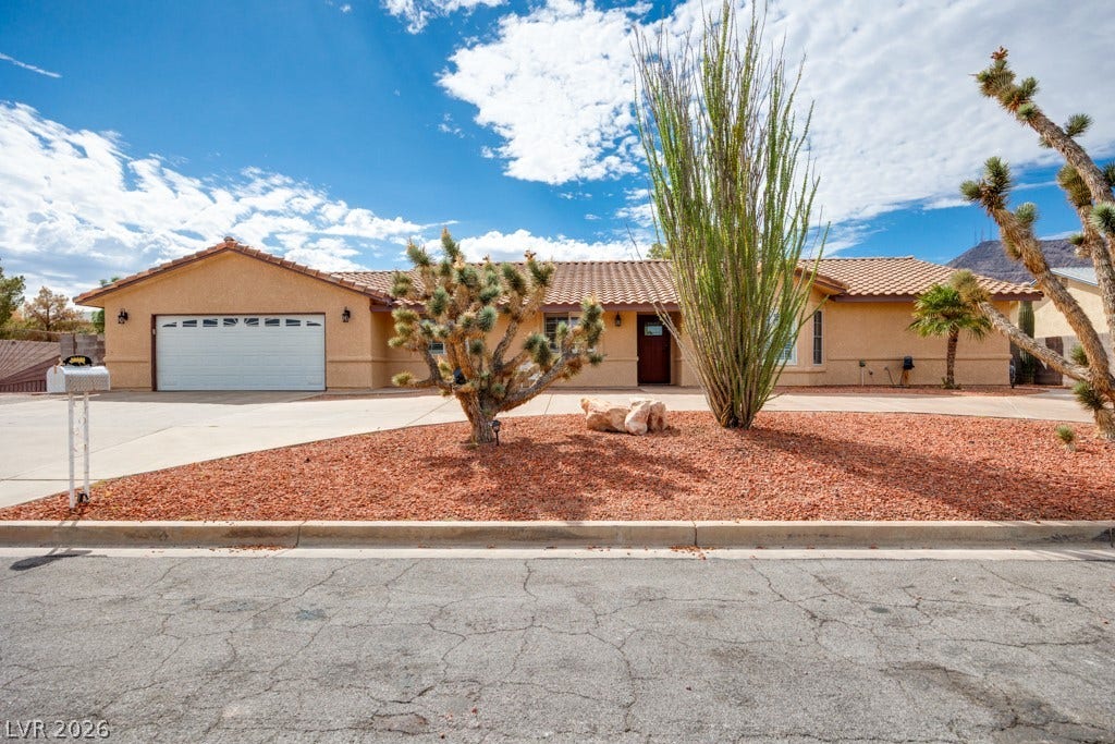 251 W Laval Drive, Henderson, NV 89015 Inviting single-story Henderson gem with classic Southwest architecture, no HOA, RV parking, mature desert landscaping, and an expansive horseshoe driveway offering plenty of off-street parking.