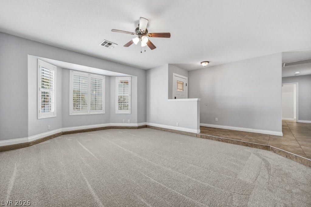 251 W Laval Drive, Henderson, NV 89015 Generously sized front living room with soft neutral finishes, abundant natural light, plantation shutters, and plenty of room to create a comfortable gathering space.