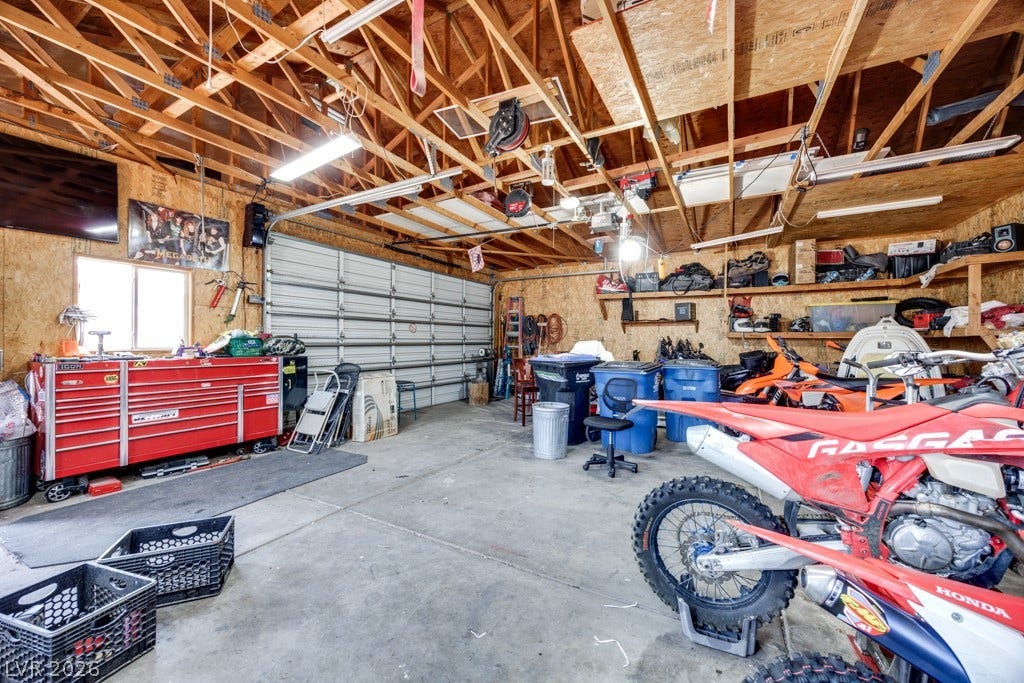 251 W Laval Drive, Henderson, NV 89015 Oversized 35' x 28.5', thoughtfully equipped detached garage/workshop offers an incredible amount of flexible workspace and storage. Finished with abundant built-in shelving, extensive work surfaces, bright overhead lighting, a swamp cooler, and plenty of room for vehicles, recreational equipment, tools, and hobbies. A true dream space for the hobbyist, mechanic, outdoor enthusiast, or anyone needing serious storage and workspace.