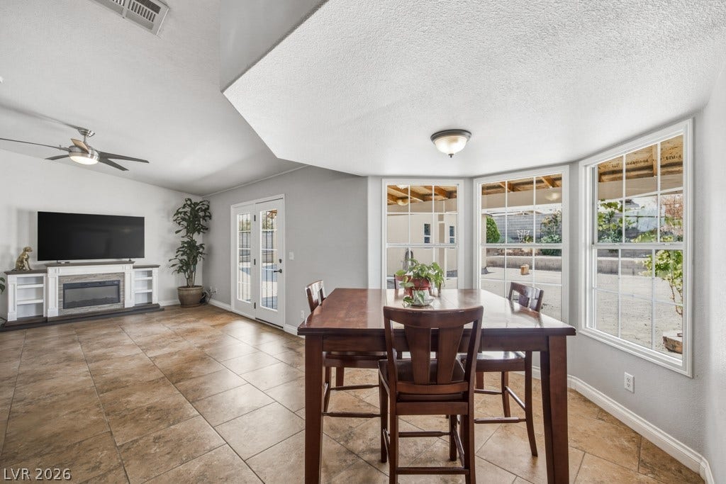 251 W Laval Drive, Henderson, NV 89015 Enjoy backyard views and abundant natural light from this bright dining space, conveniently positioned between the family room, kitchen, and outdoor living area.