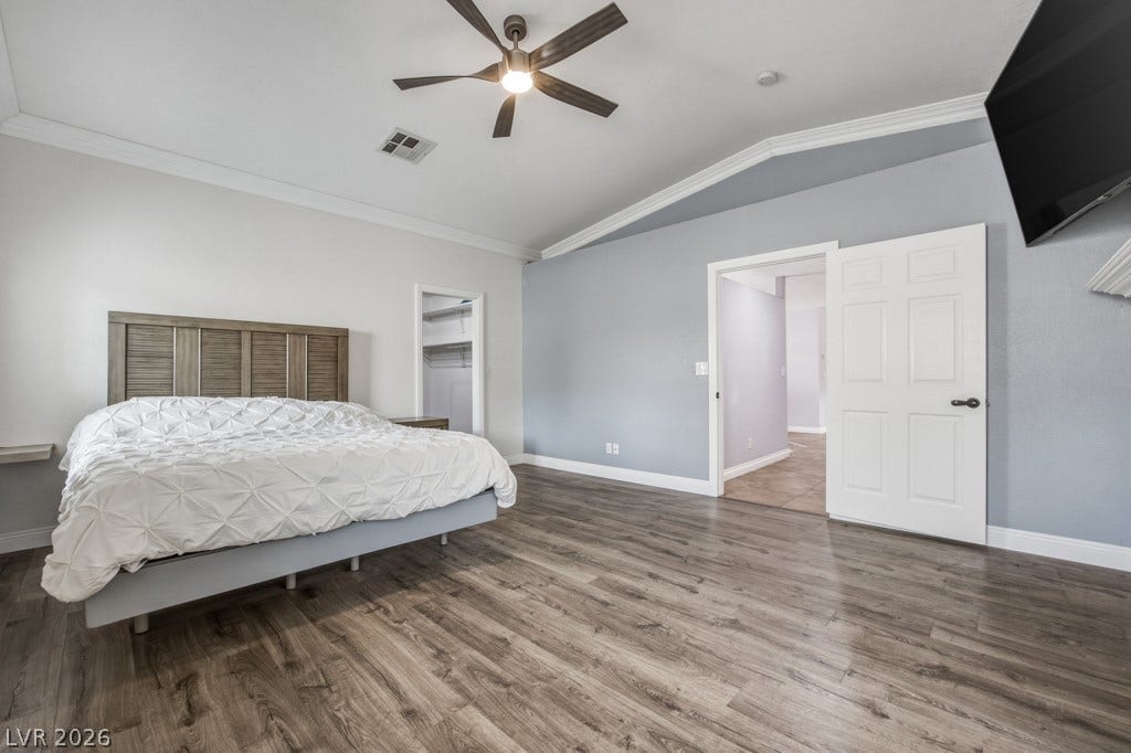 251 W Laval Drive, Henderson, NV 89015 The oversized primary suite, separate from other bedrooms, offers plenty of room to unwind, with wood-look flooring, vaulted ceilings, plantation shutters, a ceiling fan, and direct access to a large walk-in closet.