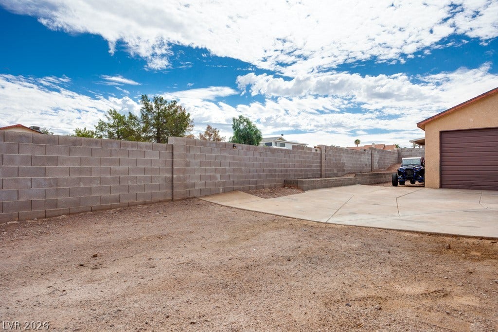 251 W Laval Drive, Henderson, NV 89015 The large backyard offers extensive RV parking alongside the detached garage/workshop-ideal for additional vehicles, recreational toys, or other storage needs.