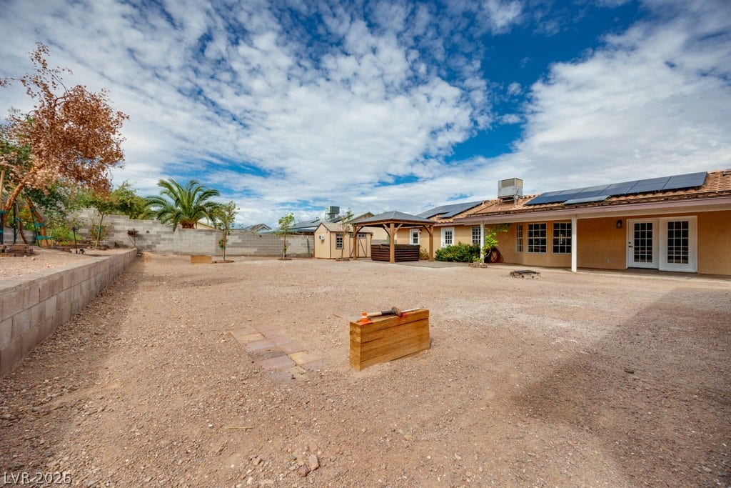 251 W Laval Drive, Henderson, NV 89015 The expansive backyard showcases just how much usable outdoor space this property offers, along with multiple covered areas and paid off solar panels on the home.