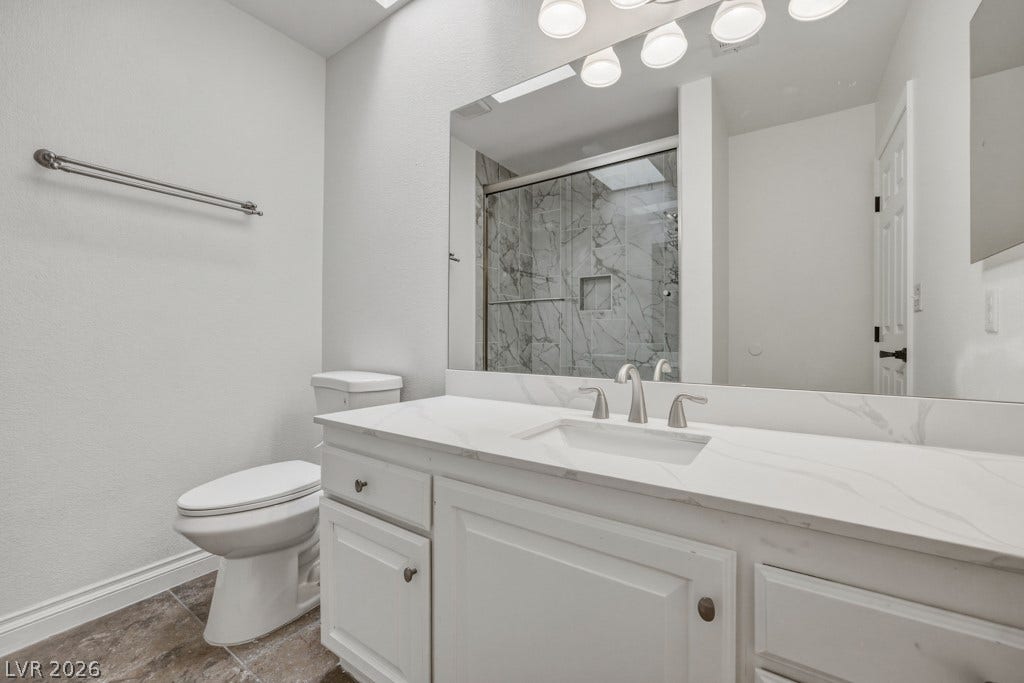 251 W Laval Drive, Henderson, NV 89015 Bright, upgraded bathroom features a spacious vanity with a sleek countertop, generous storage, and a beautifully updated tub and tile shower surround.