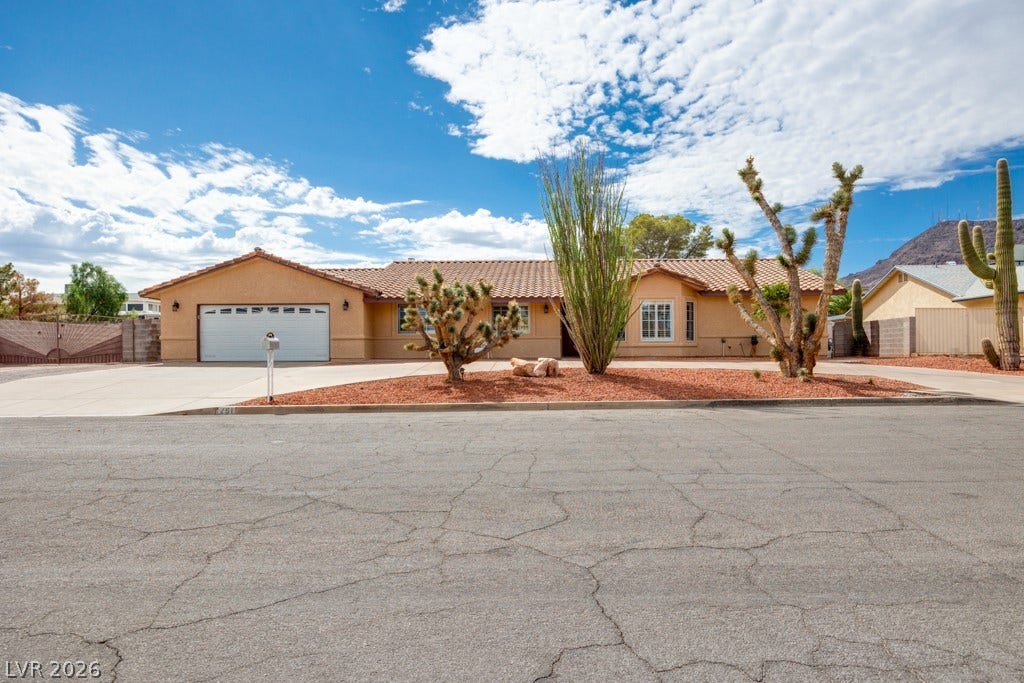 251 W Laval Drive, Henderson, NV 89015 Inviting single-story Henderson gem with classic Southwest architecture, no HOA, RV parking, mature desert landscaping, and an expansive horseshoe driveway offering plenty of off-street parking.