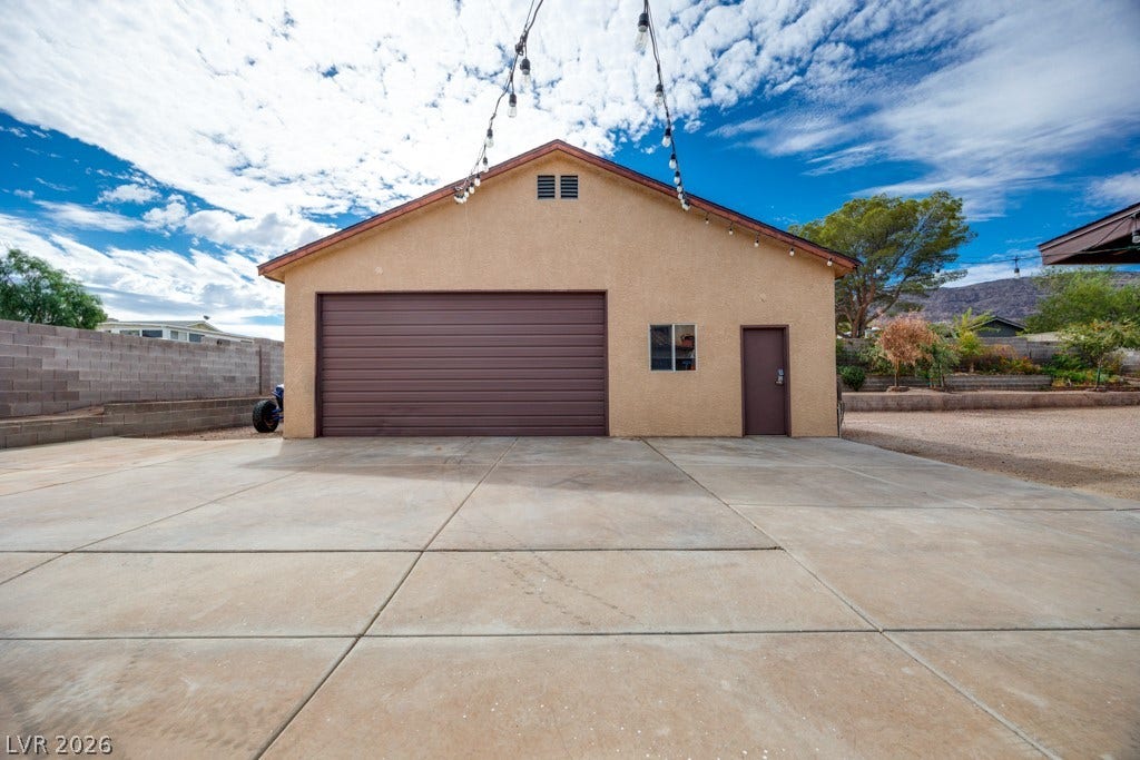 251 W Laval Drive, Henderson, NV 89015 A substantial 35' x 28.5' detached garage/workshop sits at the rear of the property with a large concrete approach and easy access from the backyard RV gate.