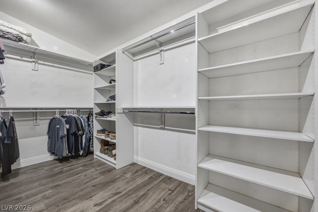 251 W Laval Drive, Henderson, NV 89015 An impressively sized primary closet features extensive built-in shelving, multiple hanging areas, and plenty of space to keep everything organized.