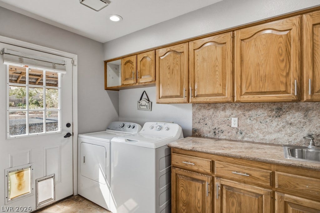 251 W Laval Drive, Henderson, NV 89015 More than just a laundry space, this generously sized room offers abundant upper and lower cabinetry, extensive counter space, a utility sink, and convenient direct access to the backyard.