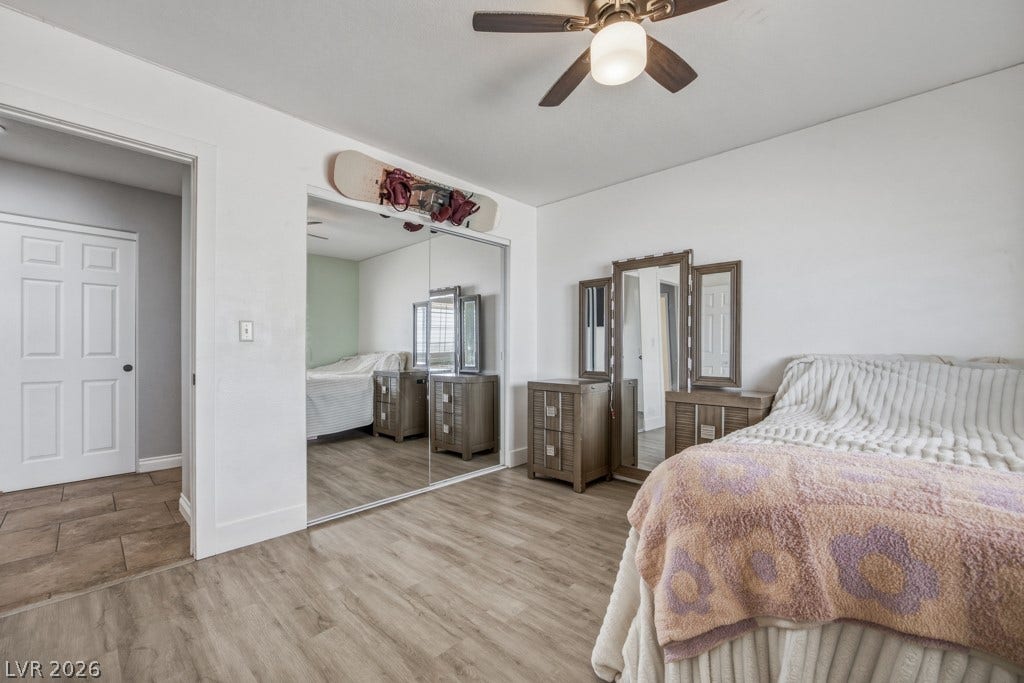 251 W Laval Drive, Henderson, NV 89015 Comfortable secondary bedroom features wood-look flooring, plantation shutters, plenty of natural light, a ceiling fan, and easy access to the guest bathroom.
