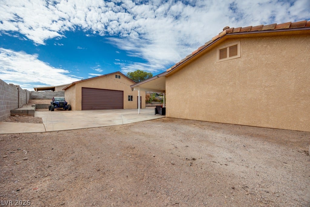 251 W Laval Drive, Henderson, NV 89015 A substantial 35' x 28.5' detached garage/workshop sits at the rear of the property with a large concrete approach and easy access from the backyard RV gate.