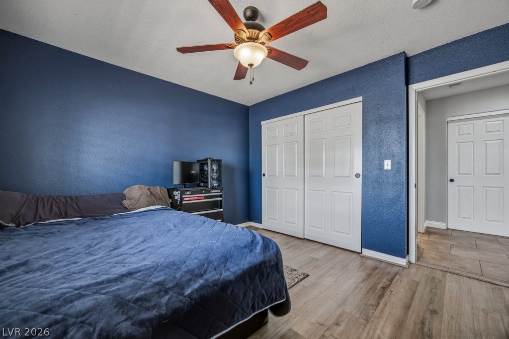 251 W Laval Drive, Henderson, NV 89015 Comfortable secondary bedroom features wood-look flooring, plantation shutters, plenty of natural light, a ceiling fan, and easy access to the guest bathroom.