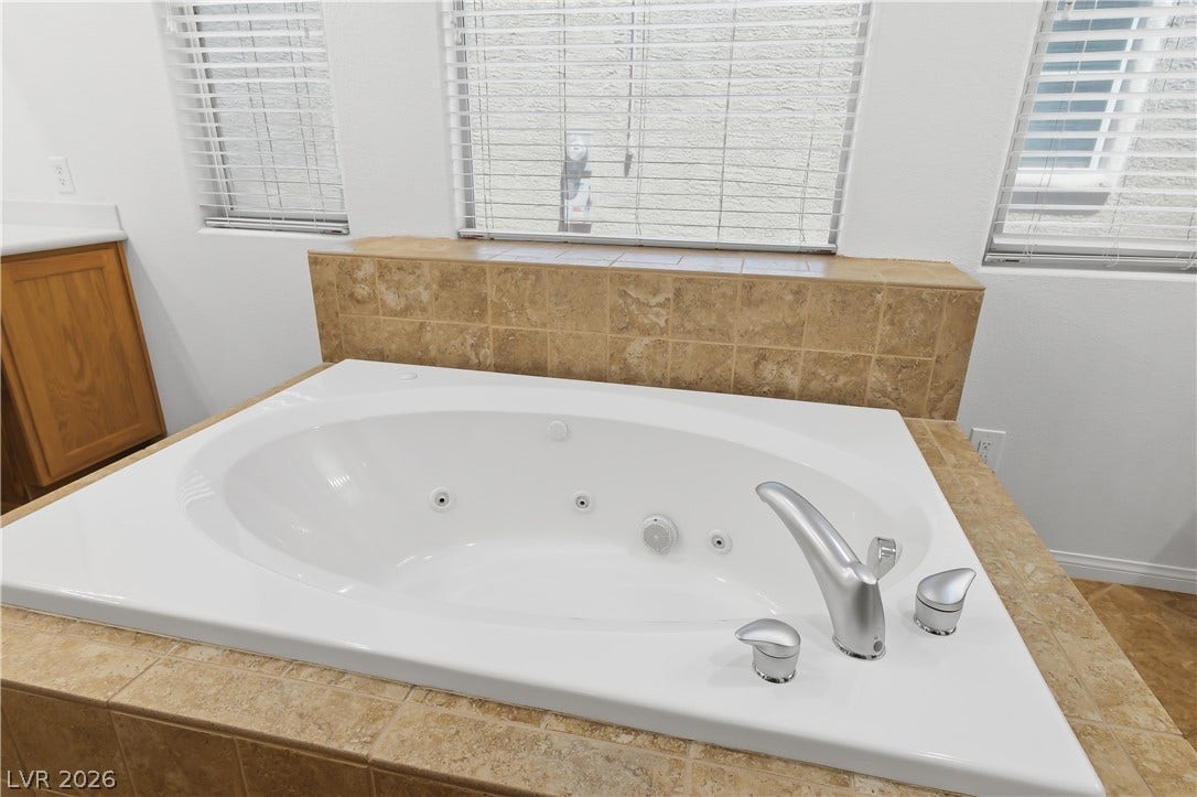 Primary Bathroom with dual sinks, dual walk in closets, separate fully tiled shower, Jetted soaking tub.m