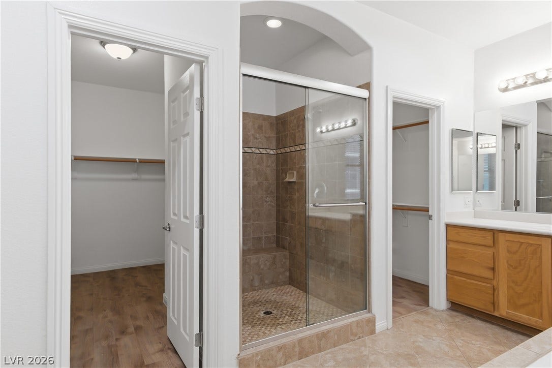 Primary Bathroom with dual walk in closets, and separate fully tiled shower.
