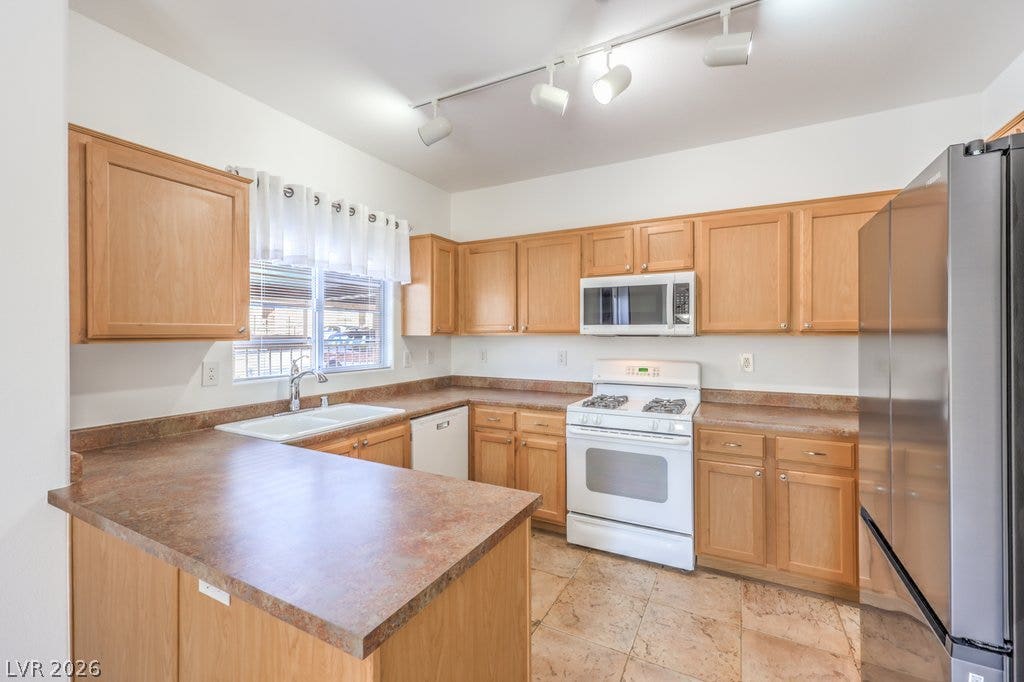 3910 Legend Hills Street, #103, Las Vegas, NV 89129 Ample wooden cabinetry and sprawling counter space define this practical culinary layout.