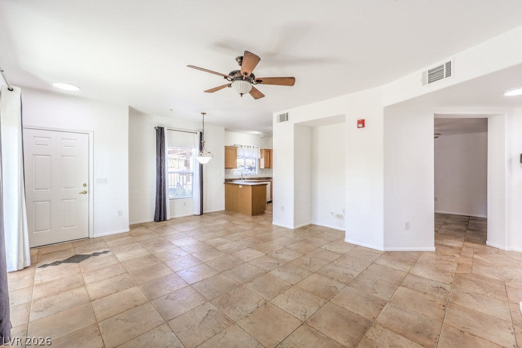 3910 Legend Hills Street, #103, Las Vegas, NV 89129 Tile flooring extends throughout the versatile open layout connecting the main entry and kitchen.