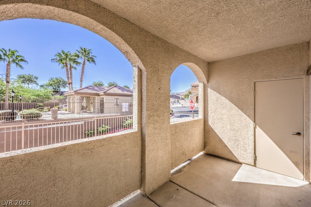3910 Legend Hills Street, #103, Las Vegas, NV 89129 Arched stucco openings frame pleasant neighborhood views from this private, concrete-finished patio.