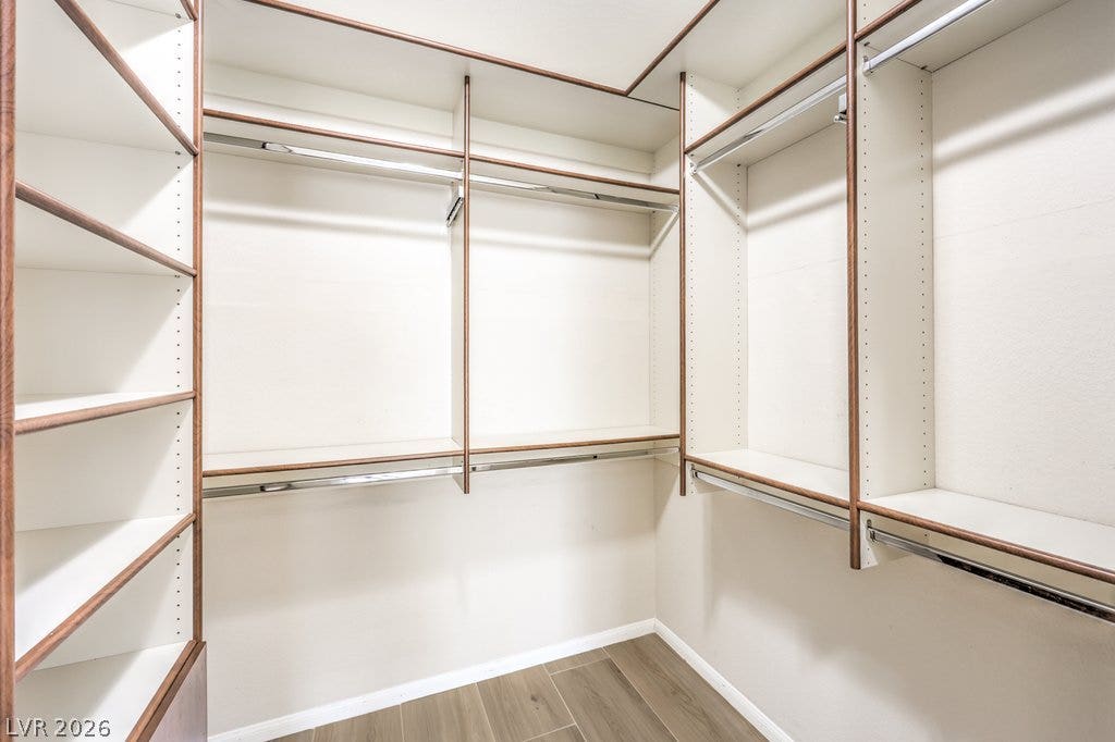 3910 Legend Hills Street, #103, Las Vegas, NV 89129 Custom wood shelving and hanging rods maximize storage space inside this walk-in closet.