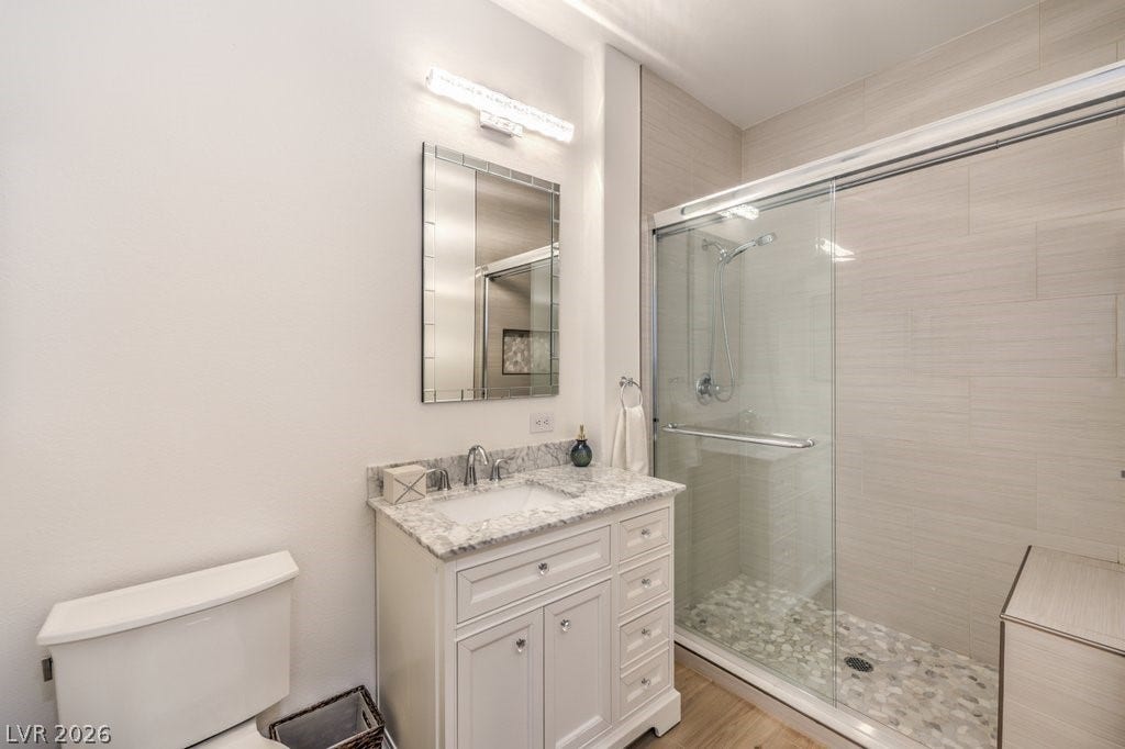 3910 Legend Hills Street, #103, Las Vegas, NV 89129 The Primary bathroom was just remodeled with all NEW tile shower, glass doors, counter & cabinet and high toilet. The faucets, mirror and light are also new.