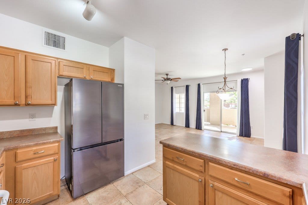 3910 Legend Hills Street, #103, Las Vegas, NV 89129 Gleaming tile floors flow from the kitchen into an airy, light-filled open living area.
