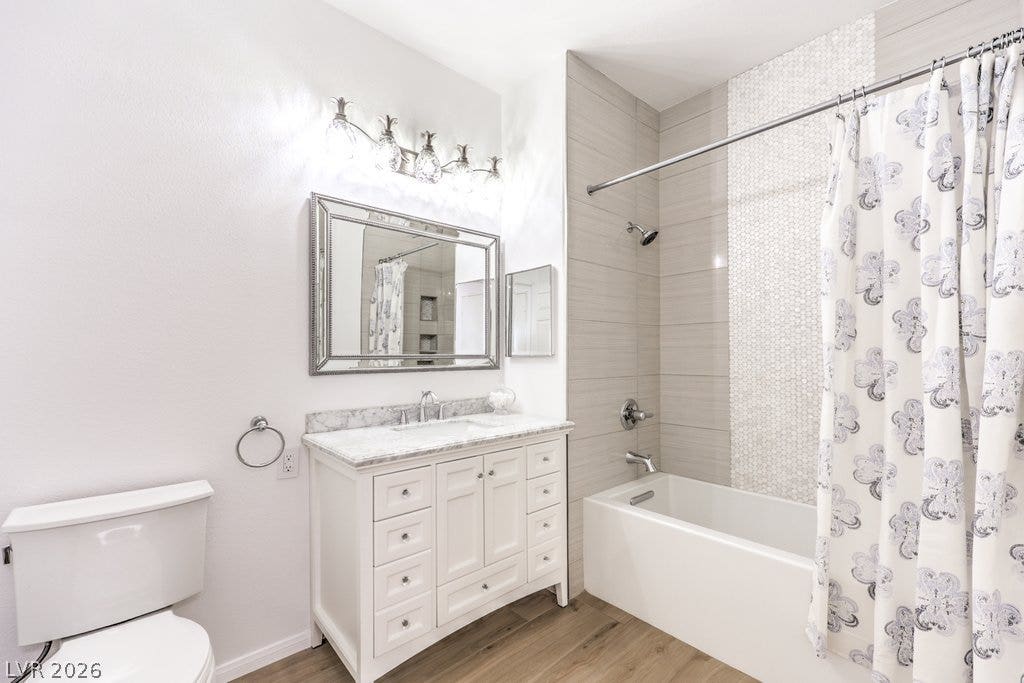 3910 Legend Hills Street, #103, Las Vegas, NV 89129 Clean tiling and a marble-topped vanity anchor this comfortable bathroom design.