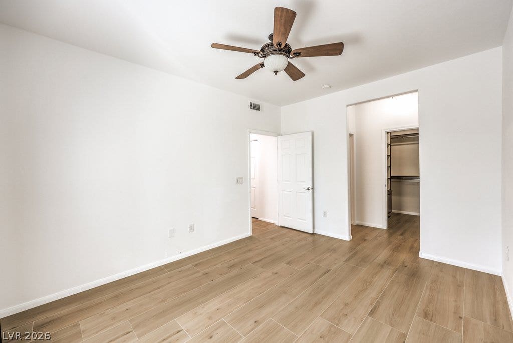 3910 Legend Hills Street, #103, Las Vegas, NV 89129 Smooth wood-look flooring and crisp white walls define this airy, versatile bedroom space.