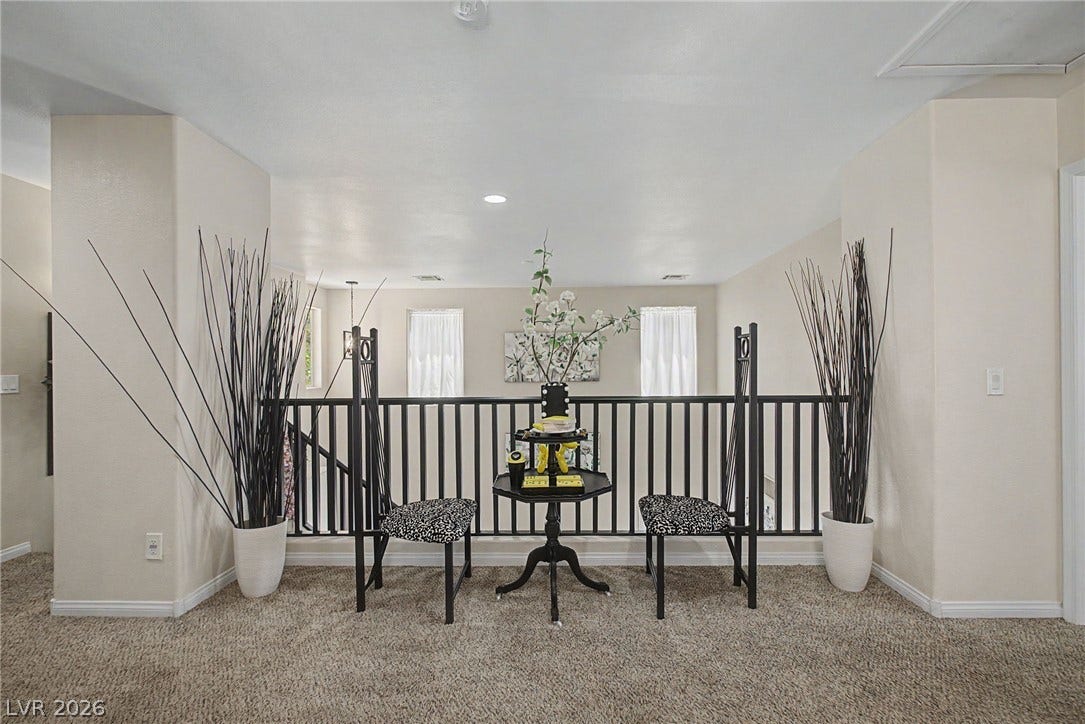 6025 Glenborough Street, North Las Vegas, NV 89115 An open upper level landing overlooks the lower floor through a secure spindle railing.