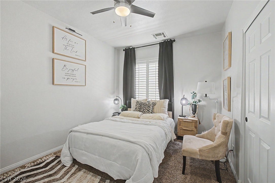 6025 Glenborough Street, North Las Vegas, NV 89115 Natural light fills this bedroom complete with neutral carpeting and classic window shutters.