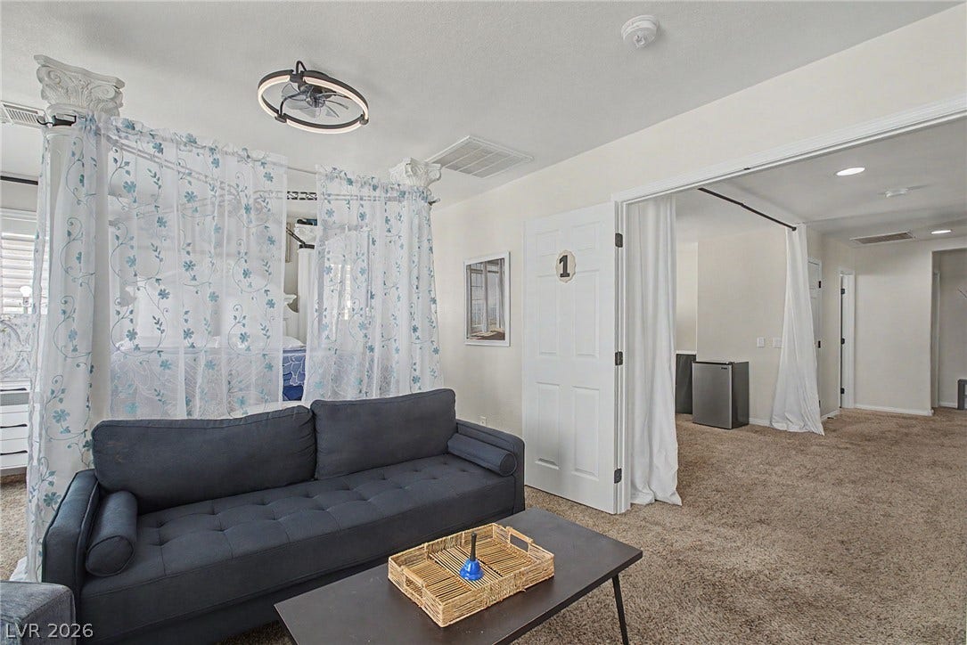 6025 Glenborough Street, North Las Vegas, NV 89115 An open layout flows between comfortable living spaces detailed with plush neutral carpeting.