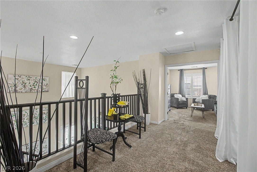 6025 Glenborough Street, North Las Vegas, NV 89115 An open upper level features carpeted flooring and recessed lighting overlooking the lower level.