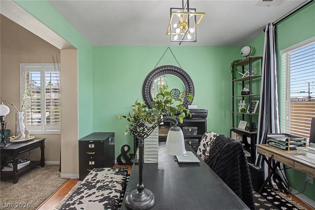 6025 Glenborough Street, North Las Vegas, NV 89115 Natural light pours through large windows into this versatile and functional home workspace.