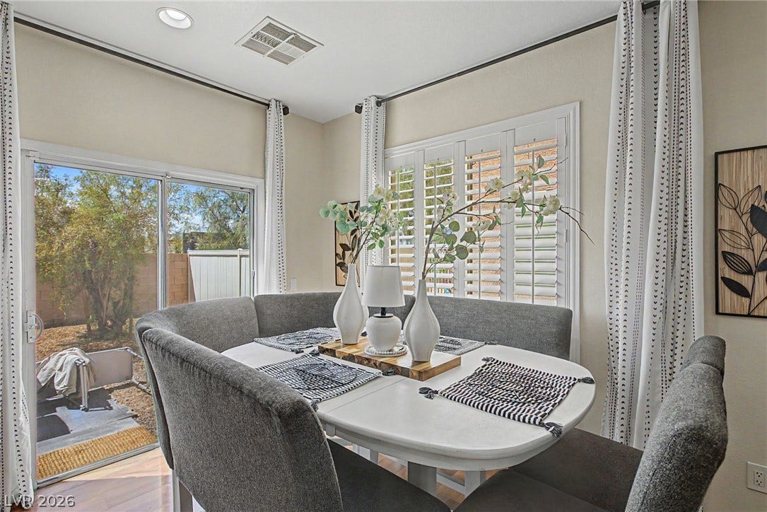 6025 Glenborough Street, North Las Vegas, NV 89115 Crown molding frames this charming dining space complete with plantation shutters and sliding glass doors.