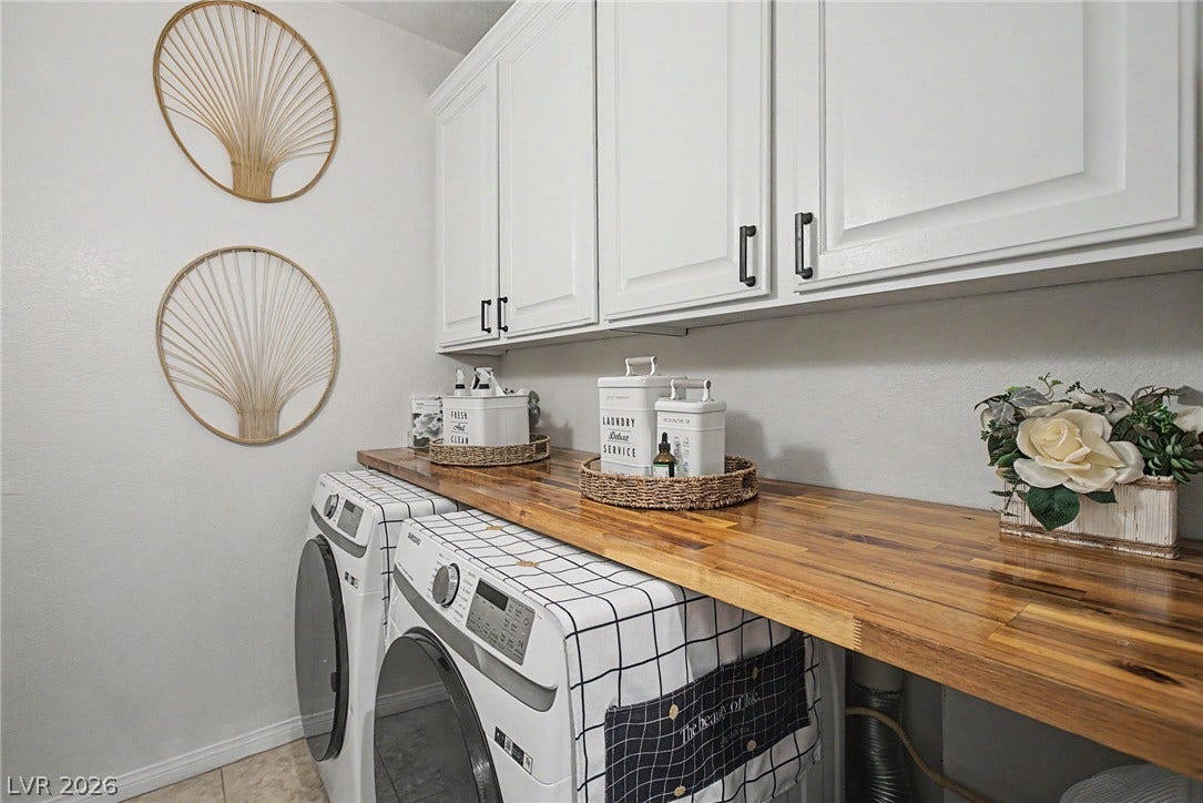 6025 Glenborough Street, North Las Vegas, NV 89115 Ample cabinetry and a warm wood folding counter elevate this highly functional laundry setup.