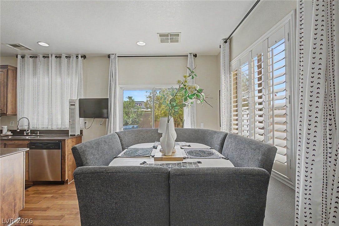 6025 Glenborough Street, North Las Vegas, NV 89115 Gleaming hardwood floors and abundant natural light define this inviting dining area.