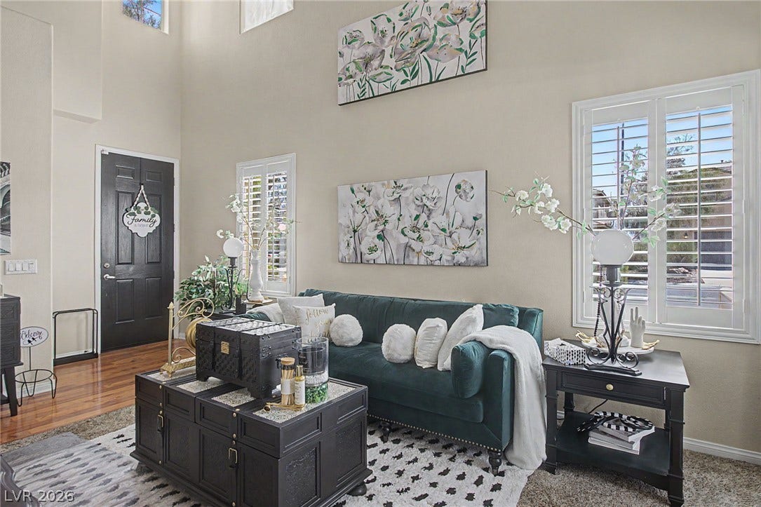 6025 Glenborough Street, North Las Vegas, NV 89115 Towering ceilings and plantation shutters bring architectural character to this inviting entry living area.