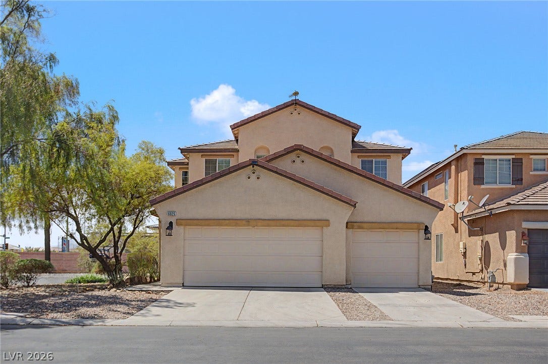 6025 Glenborough Street, North Las Vegas, NV 89115 A spacious concrete driveway leads to the three-car garage of this multi-level home.