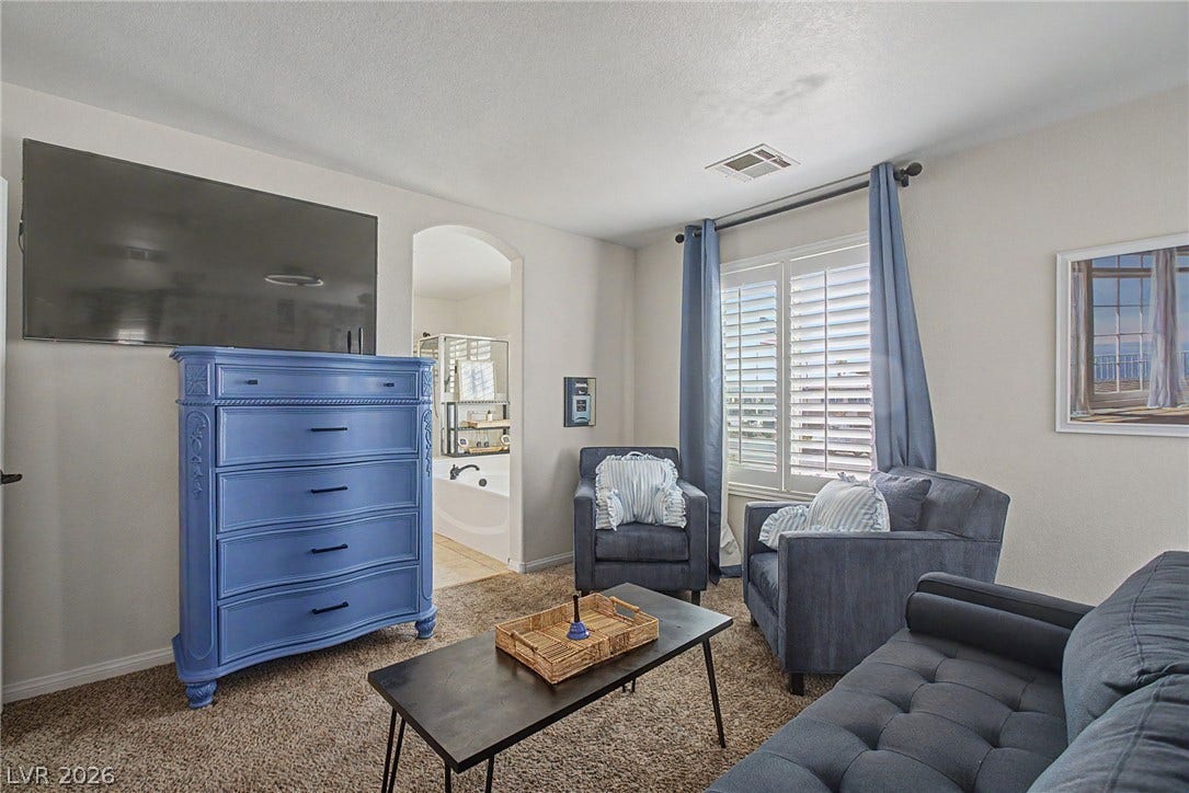 6025 Glenborough Street, North Las Vegas, NV 89115 An arched doorway leads to the master bathroom from this cozy sitting area.