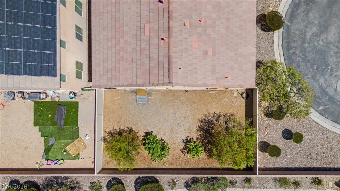 6025 Glenborough Street, North Las Vegas, NV 89115 An aerial perspective showcases the tiled roofline and fenced yard of this property.