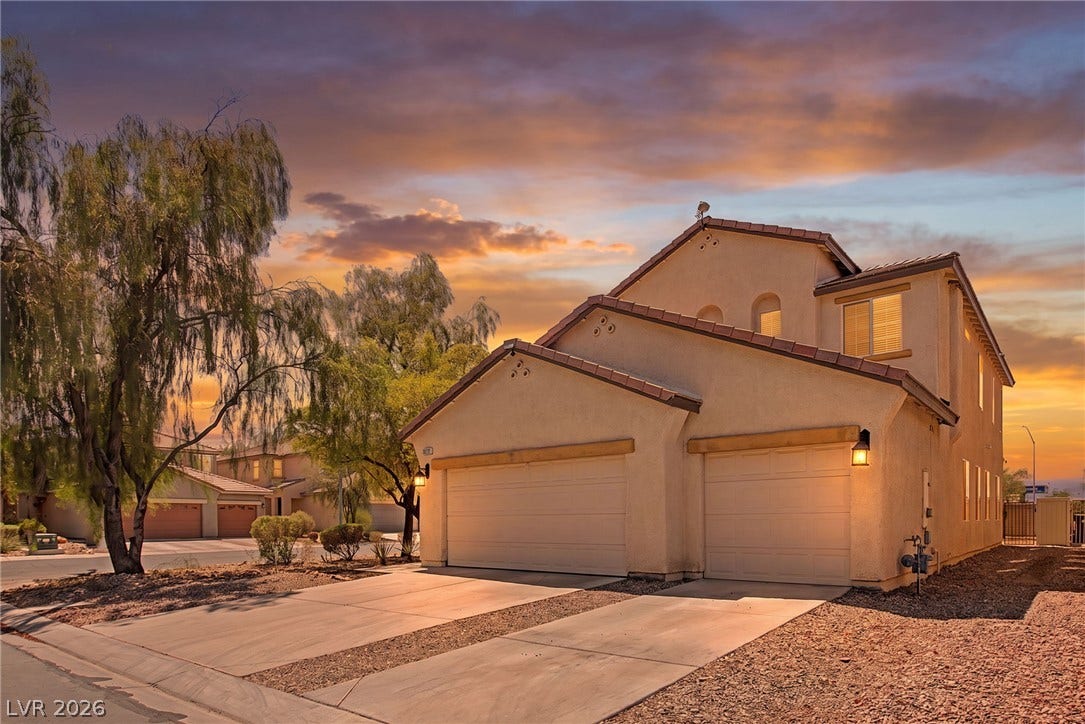 6025 Glenborough Street, North Las Vegas, NV 89115 Stucco exterior and multi-bay garage defined by classic tile roofing lines.