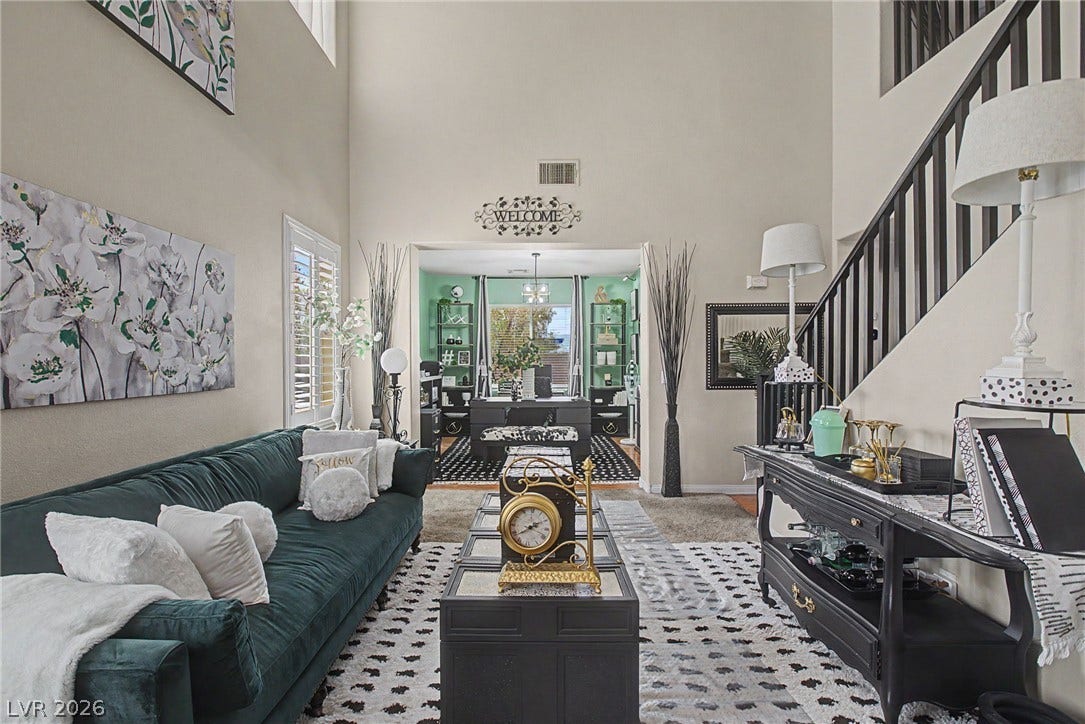 6025 Glenborough Street, North Las Vegas, NV 89115 Towering ceilings and an open staircase create an airy feel in this comfortable living space.
